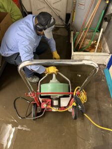 plumber cleaning a drain